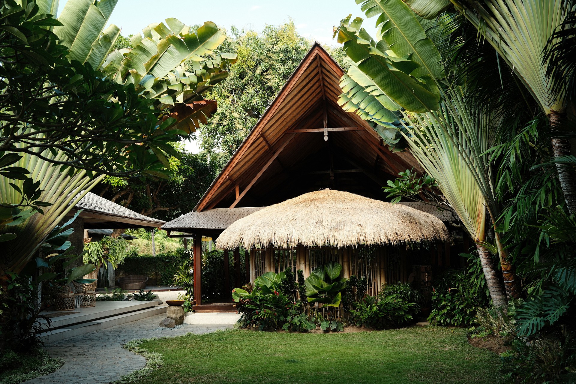 Tropical resort villa with hut and lush garden in Bali